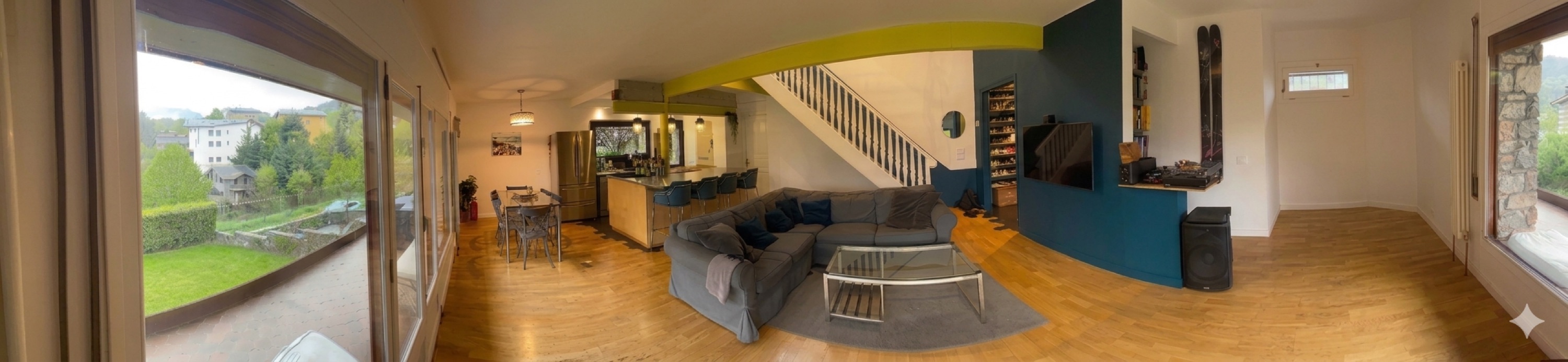 Panoramic view of open-plan living area with garden views